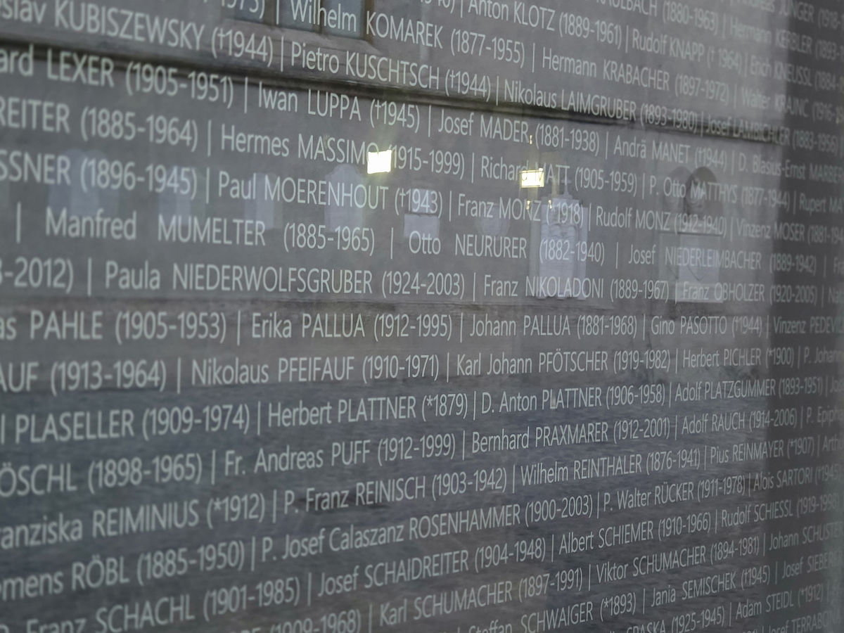 Eine gläserne Gedenktafel mit zahlreichen Namen und Geburts- und Sterbejahr der Geehrten, darunter Erika Pallua